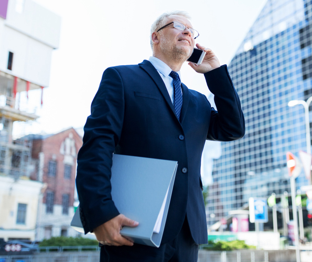 senior-businessman-calling-on-smartphone-in-city-2024-09-27-22-11-08-utc